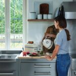 KitchenAid Artisan 2-slot stainless steel toaster in Almond Cream in use — photo 6